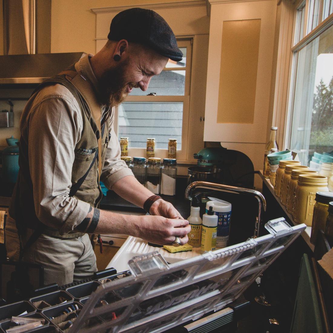 A technician fine-tunes a kitchen faucet aerator
