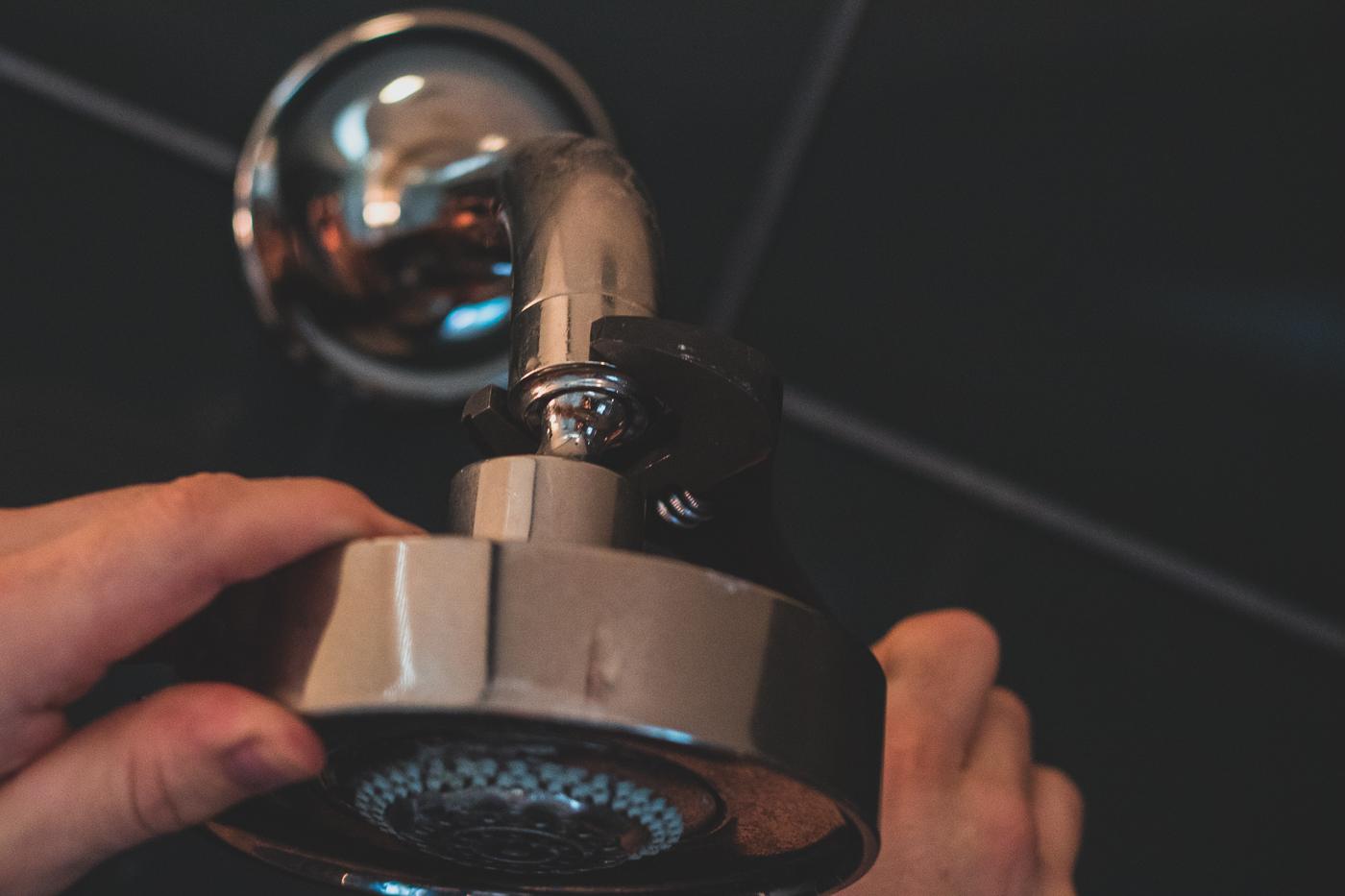 A technician installs a high-performance showerhead